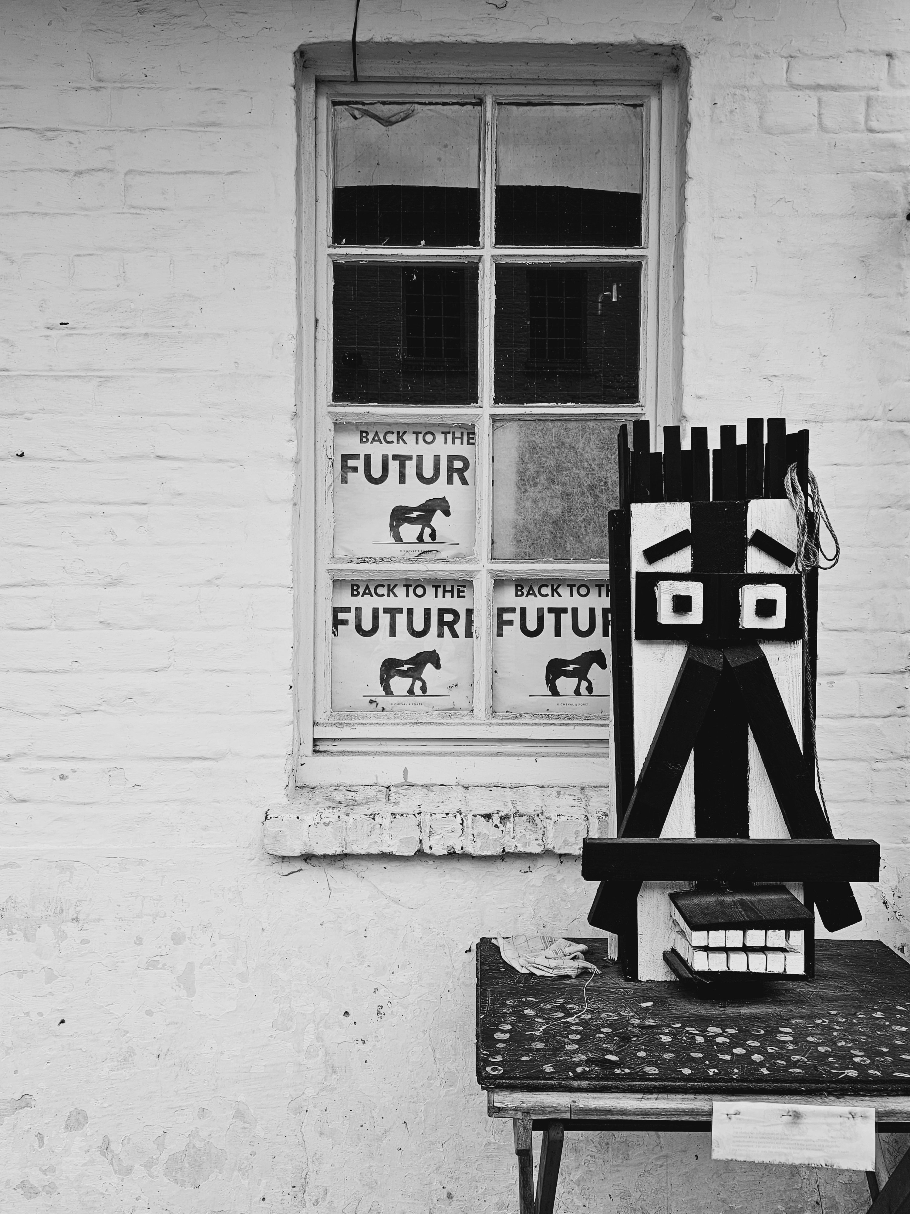 Monochrome photo of abstract urban art near window with 'Back to the Future' text