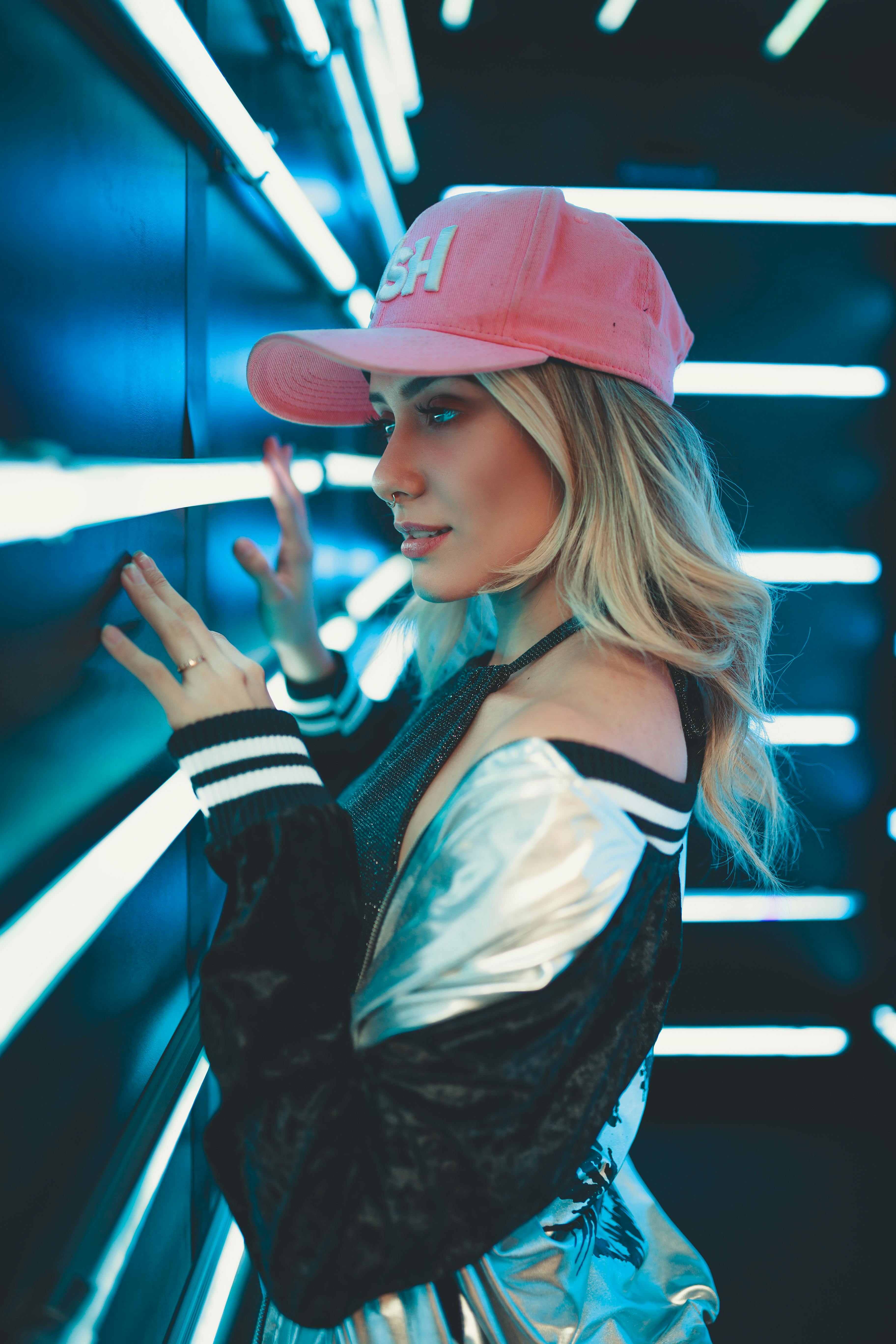 woman standing and facing wall with led lights