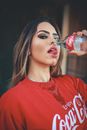 Photo of Woman Holding a Bottle
