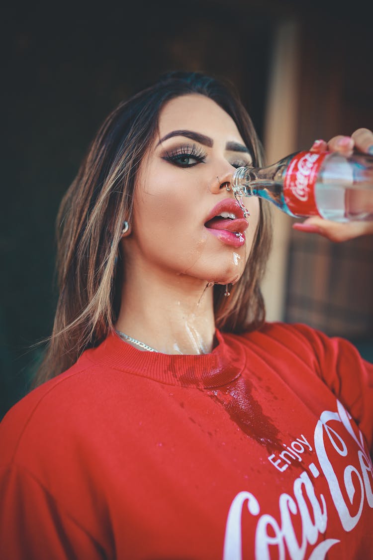 Photo Of Woman Holding A Bottle