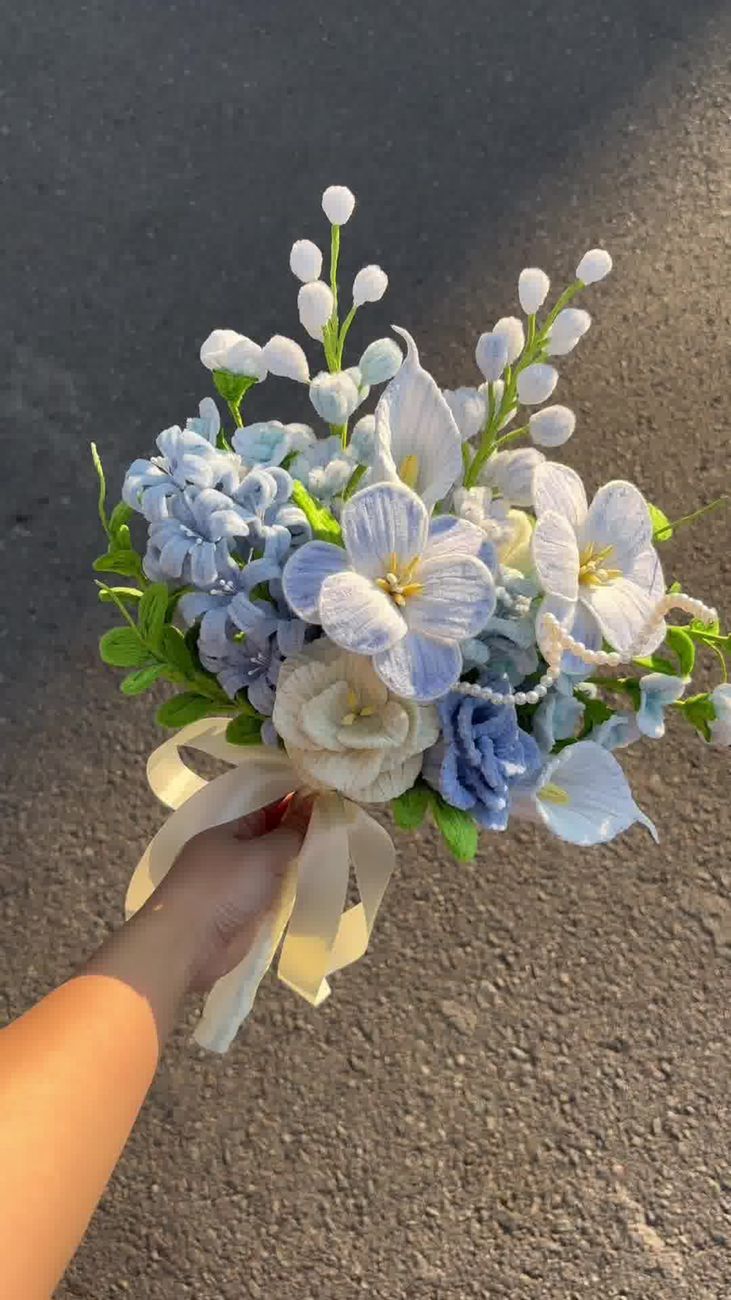 Elegant bouquet with blue and white flowers, perfect for weddings or events.
