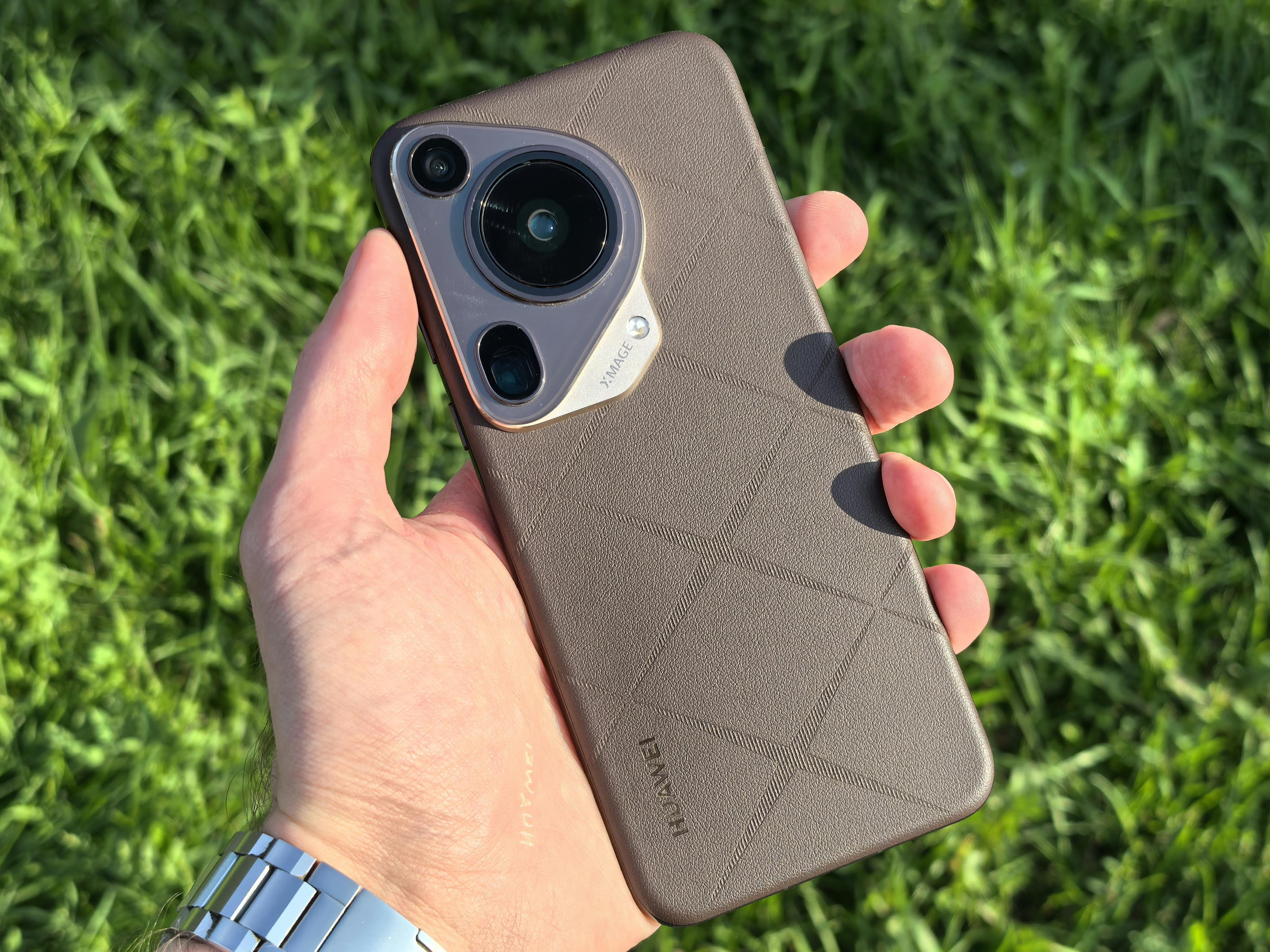 Hand Holding Smartphone Outdoors in Sunlight