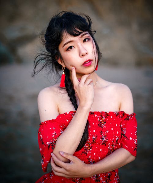 Selective Focus Photography of Woman Wearing Red Off-shoulder Dress