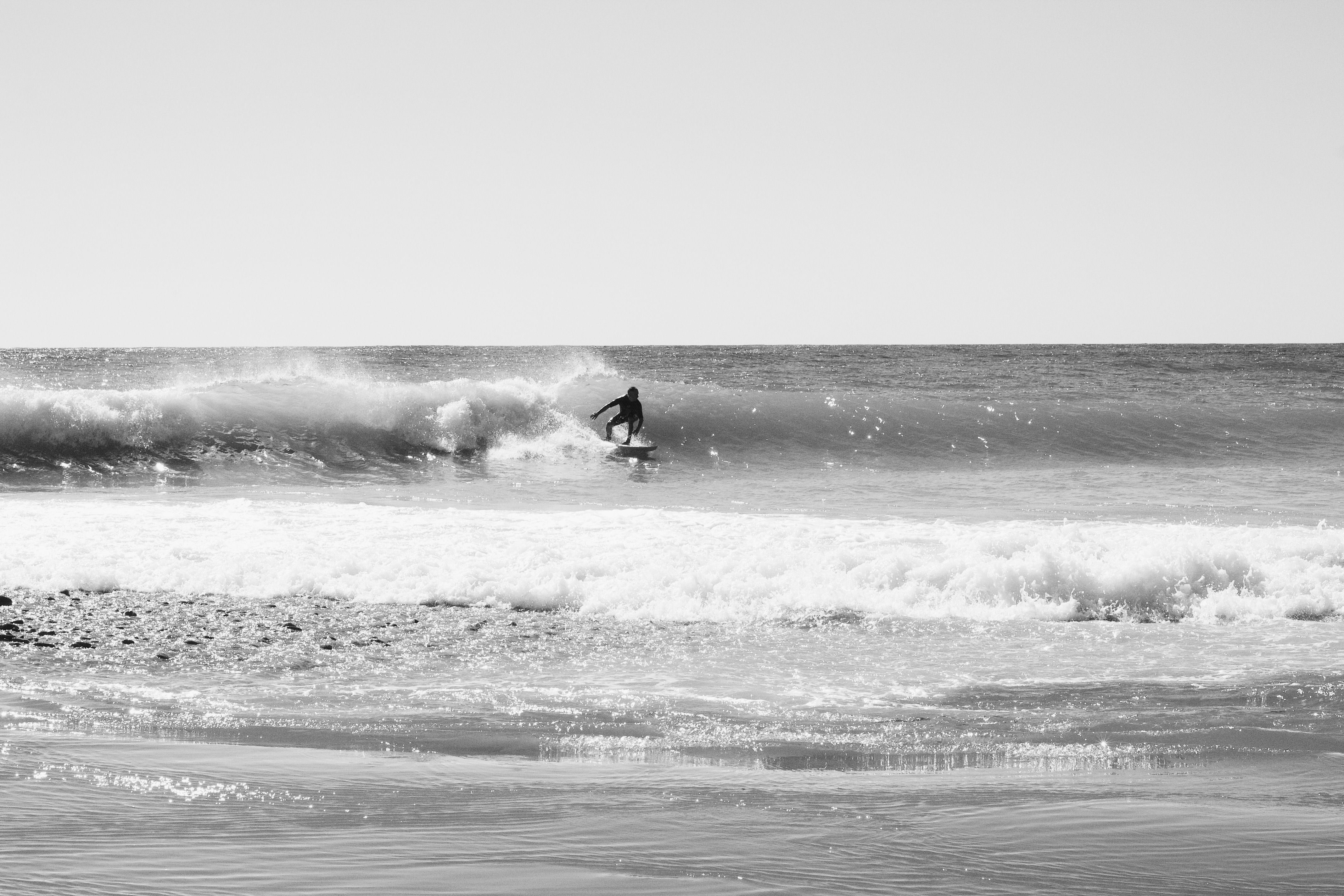 Black and White Surfer Catching a Wave in Sochi · Free Stock Photo