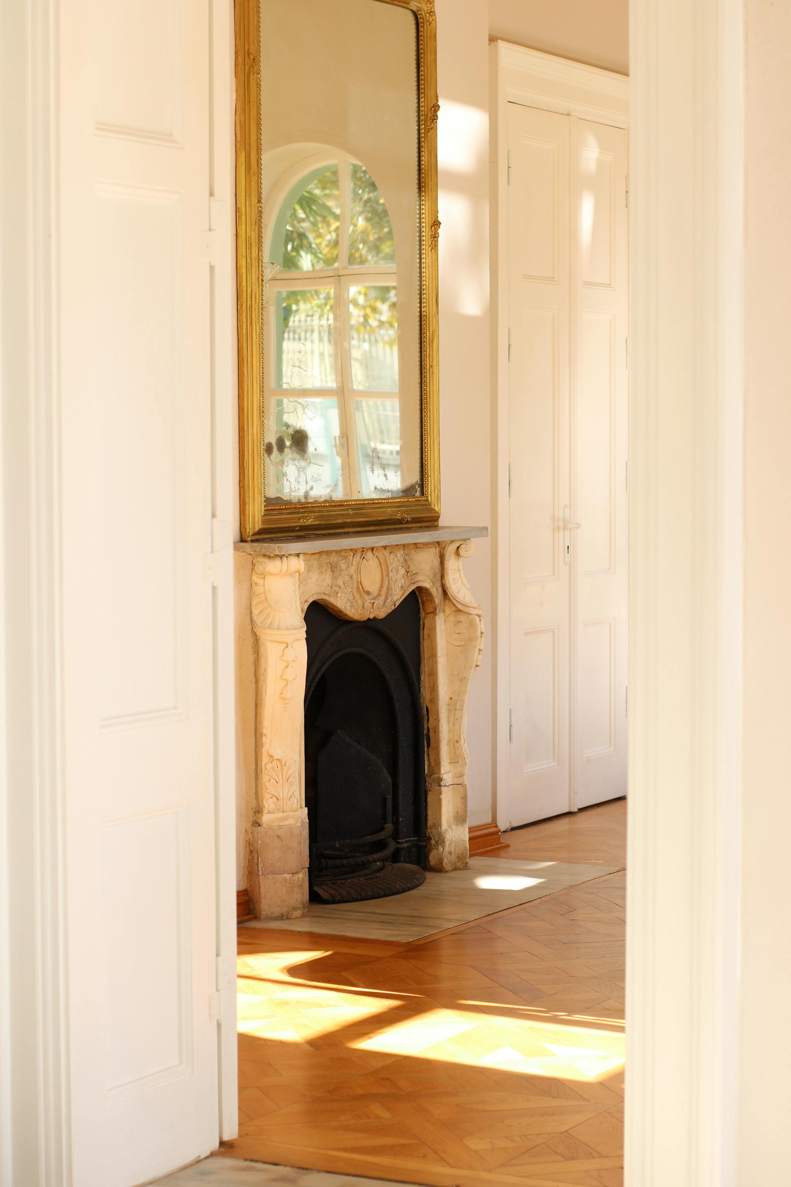 Elegant sunlit interior with antique mirror