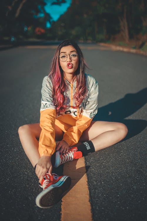 Woman Sitting on Road