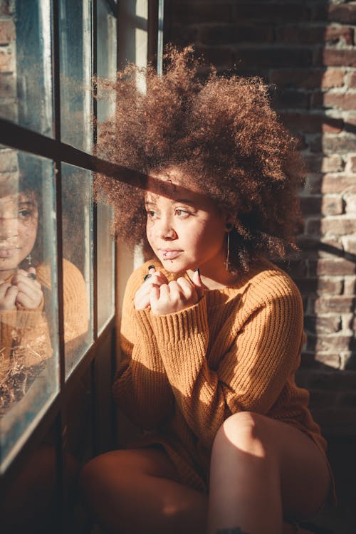 Woman Sitting Beside Window