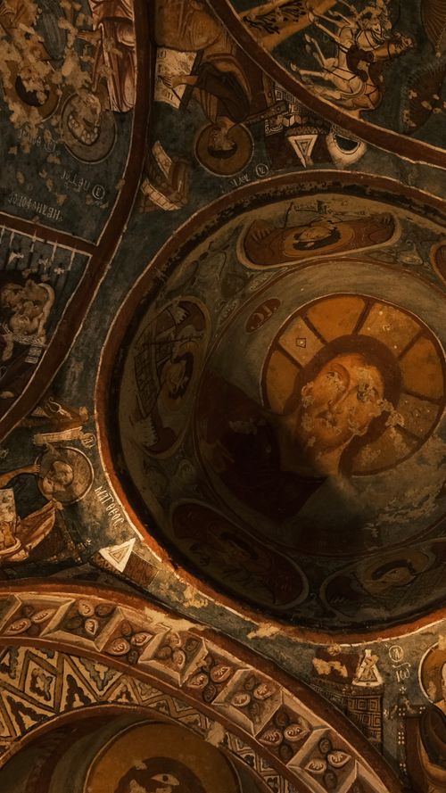 Free Intricate fresco depicting biblical scenes in a cave church in Cappadocia, Türkiye. Stock Photo