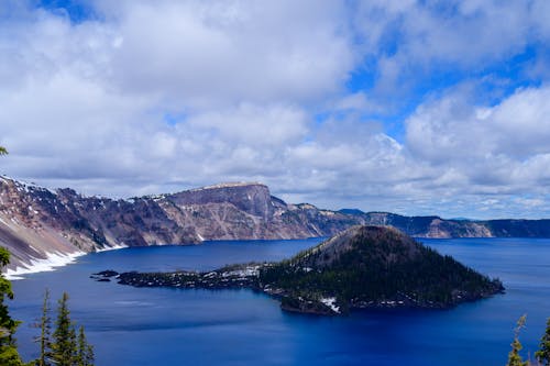 Free Photo of Island Surrounded by the Lake Under Cloudy Sky Stock Photo