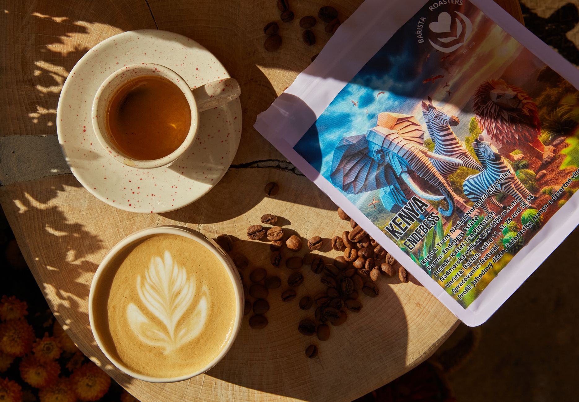 Stylish flat lay of Kenyan espresso and latte art with coffee beans and packaging.