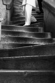 Abstract black and white photo of ascending concrete stairs in Istanbul, capturing movement.