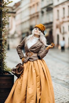 Portrait of a stylish woman in Victorian clothing on a historic city street.