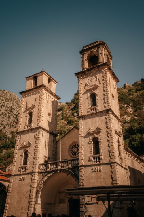 Free Scenic view of the Kotor Cathedral towers against a mountainous backdrop. Stock Photo