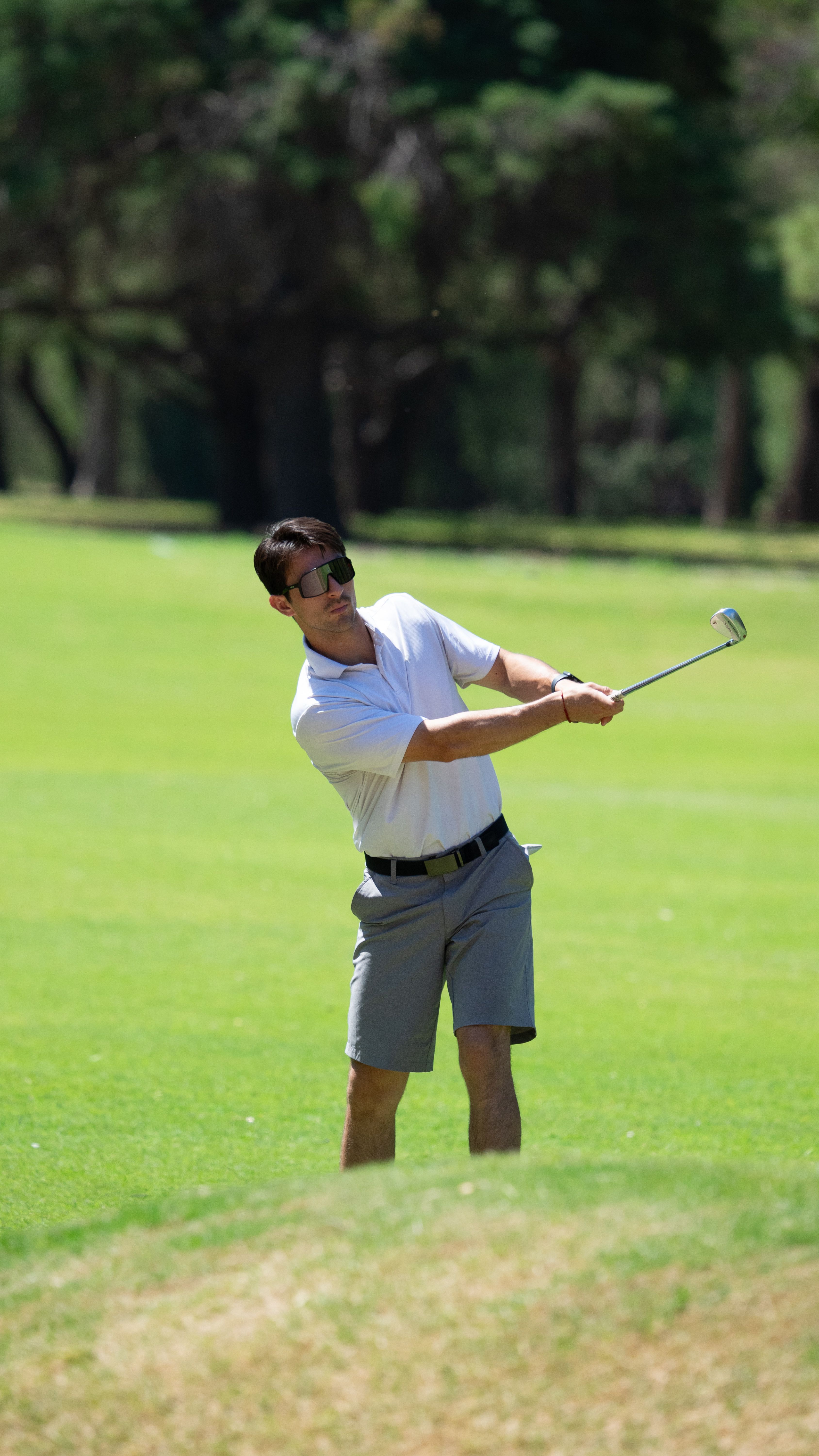 A golfer in action on a bright and sunny day, showcasing perfect form and focus.