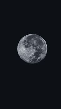 Captivating full moon in black and white at night, perfect for backgrounds.