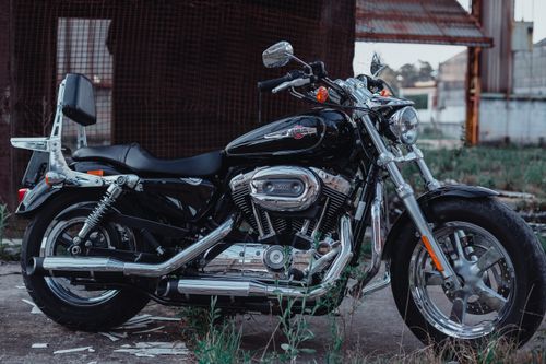 Free A sleek black motorcycle with chrome features photographed in an outdoor setting. Stock Photo