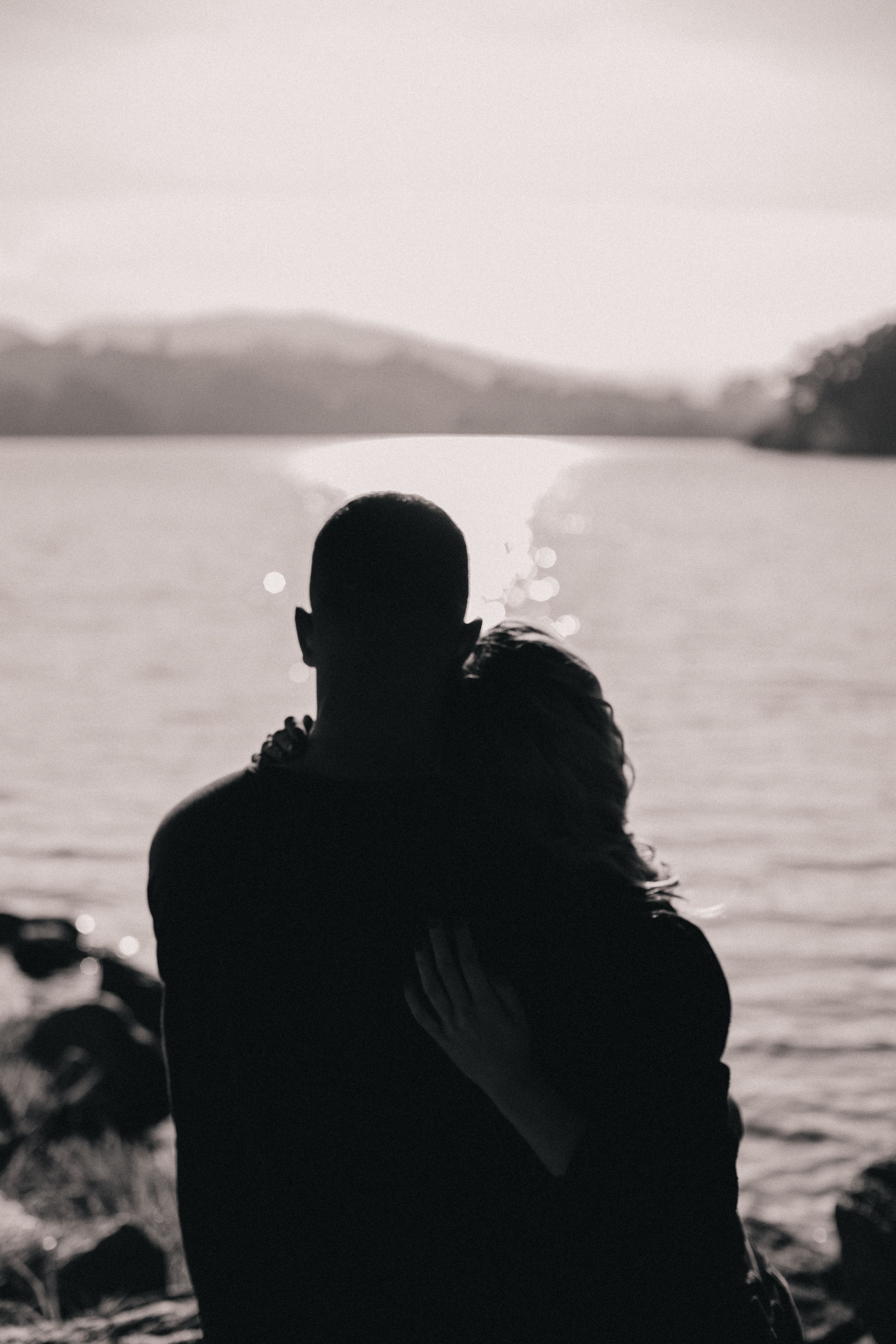 Silhouette Couple Embrace by Serene Lake · Free Stock Photo