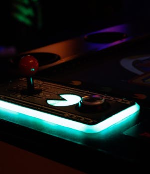 Close-up of a vintage arcade machine joystick glowing under ambient light, evoking nostalgic gaming vibes.