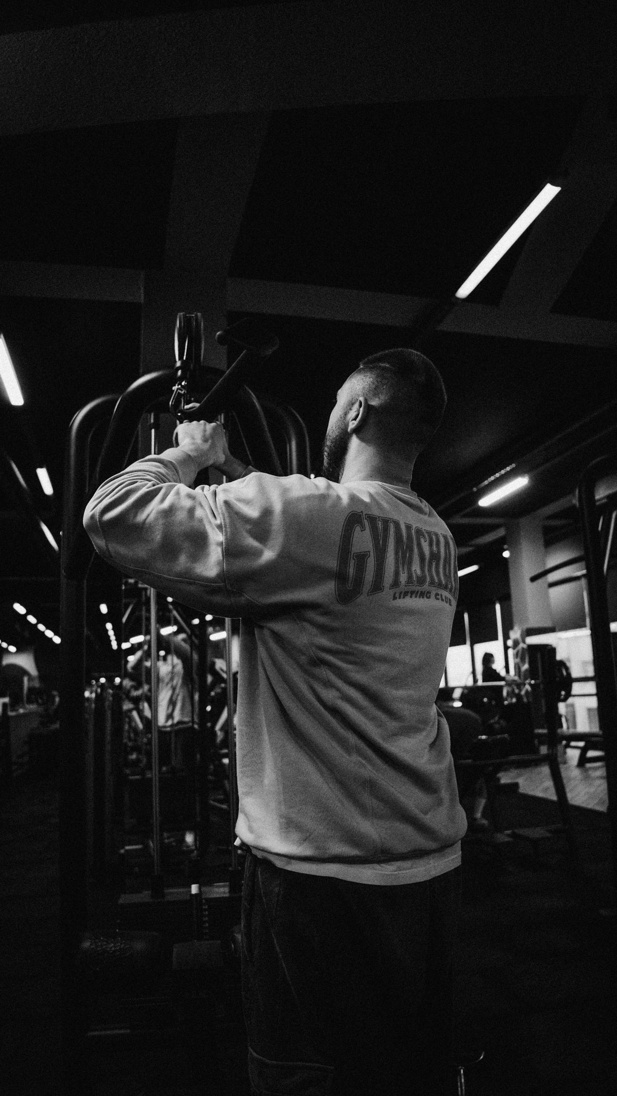 High-contrast black and white cinematic shot of a professional athletic training lab