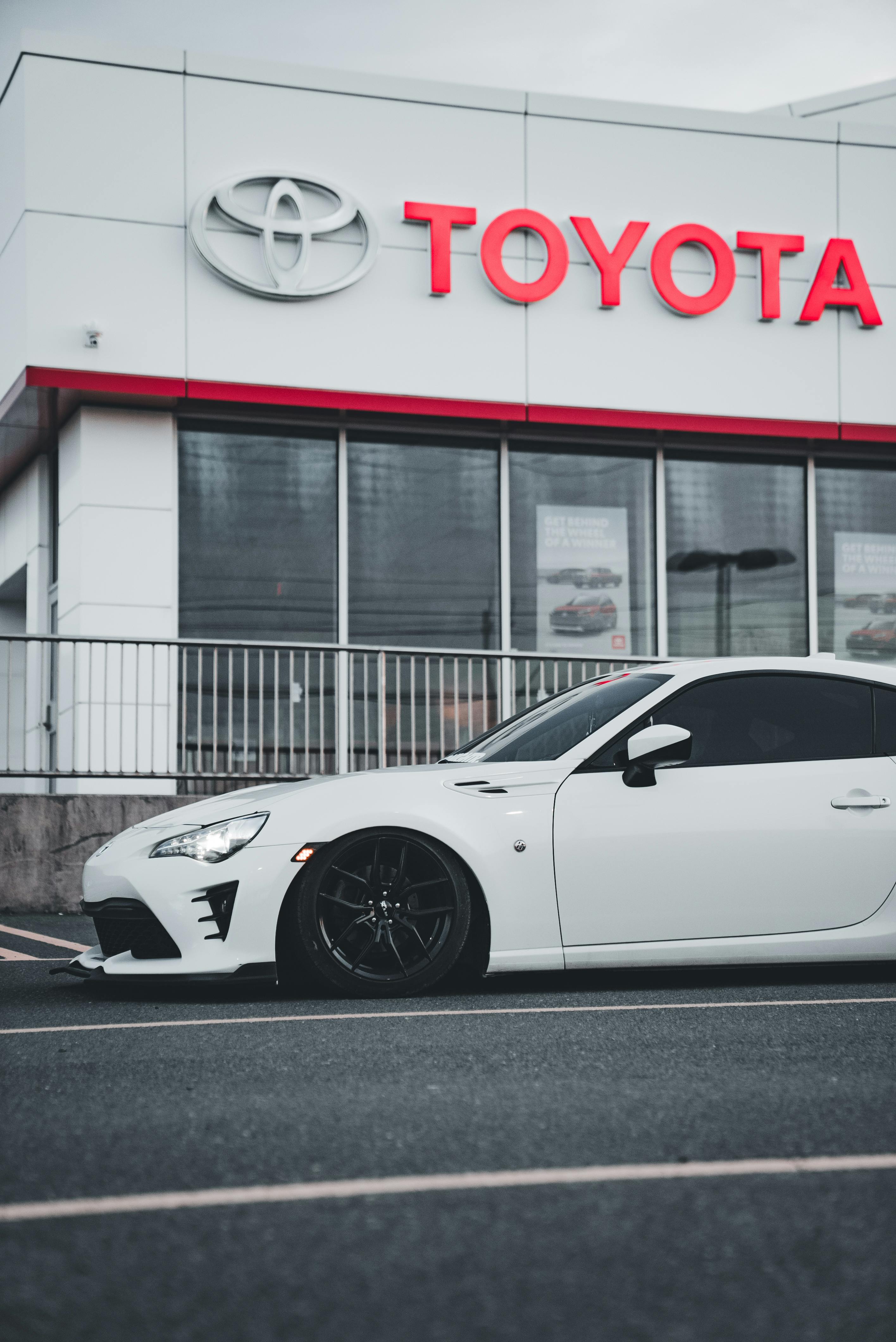 Car dealership sign in front of an urban skyline