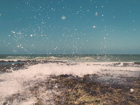 Captivating ocean waves splashing against the shore at Barra do Cunhaú, Rio Grande do Norte, Brasil.