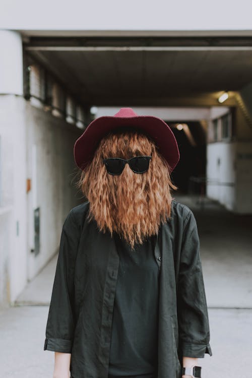 Person's Face Covered with Hair Wearing Sunglasses