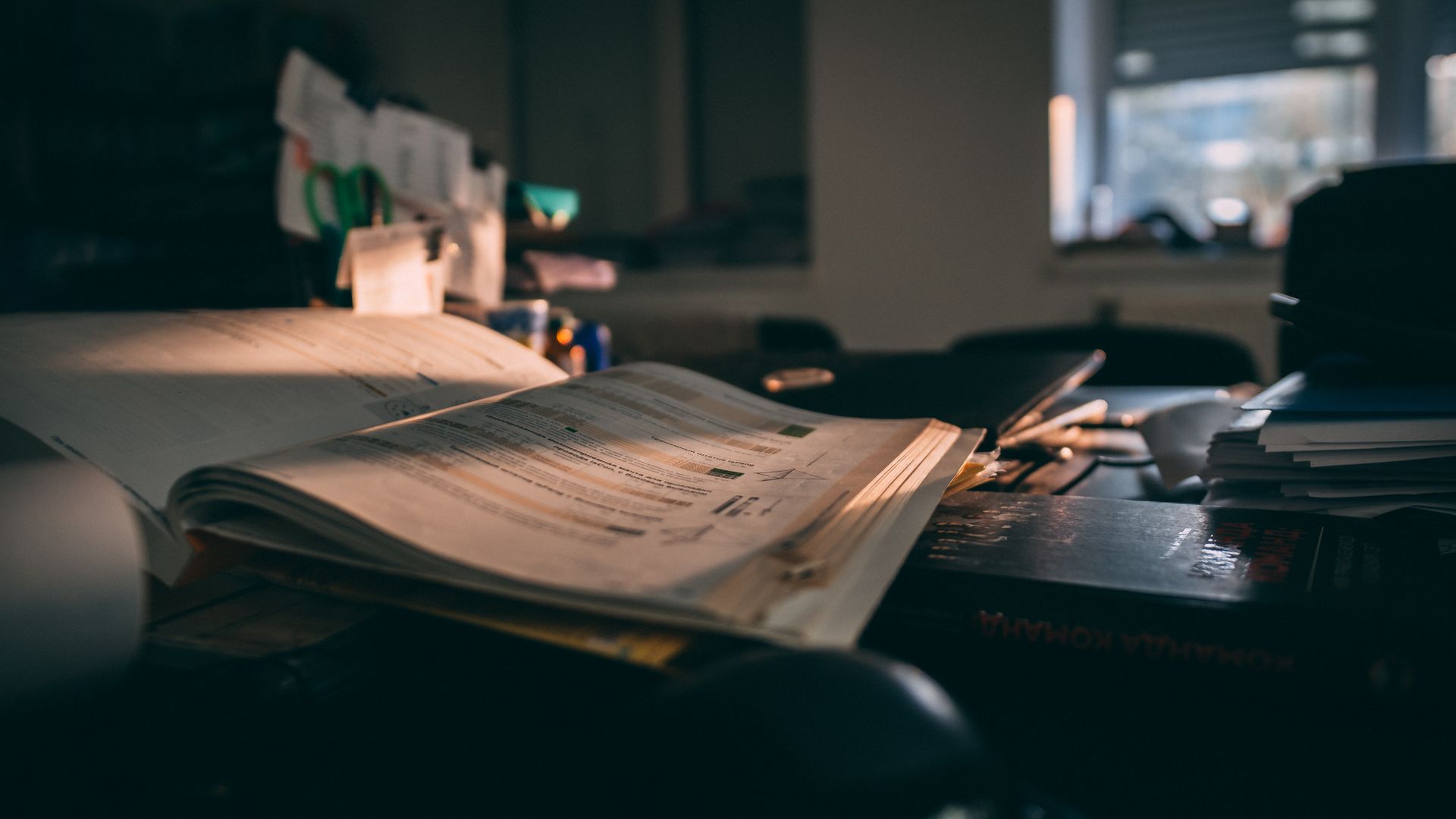 Open Bible beside business planning documents on professional desk