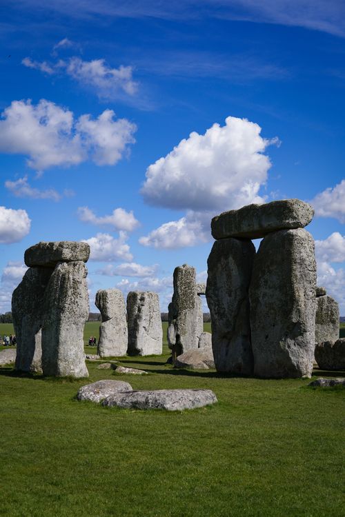 Free Stonehenge with blue skies and white clouds, capturing ancient architecture and mystery. Stock Photo