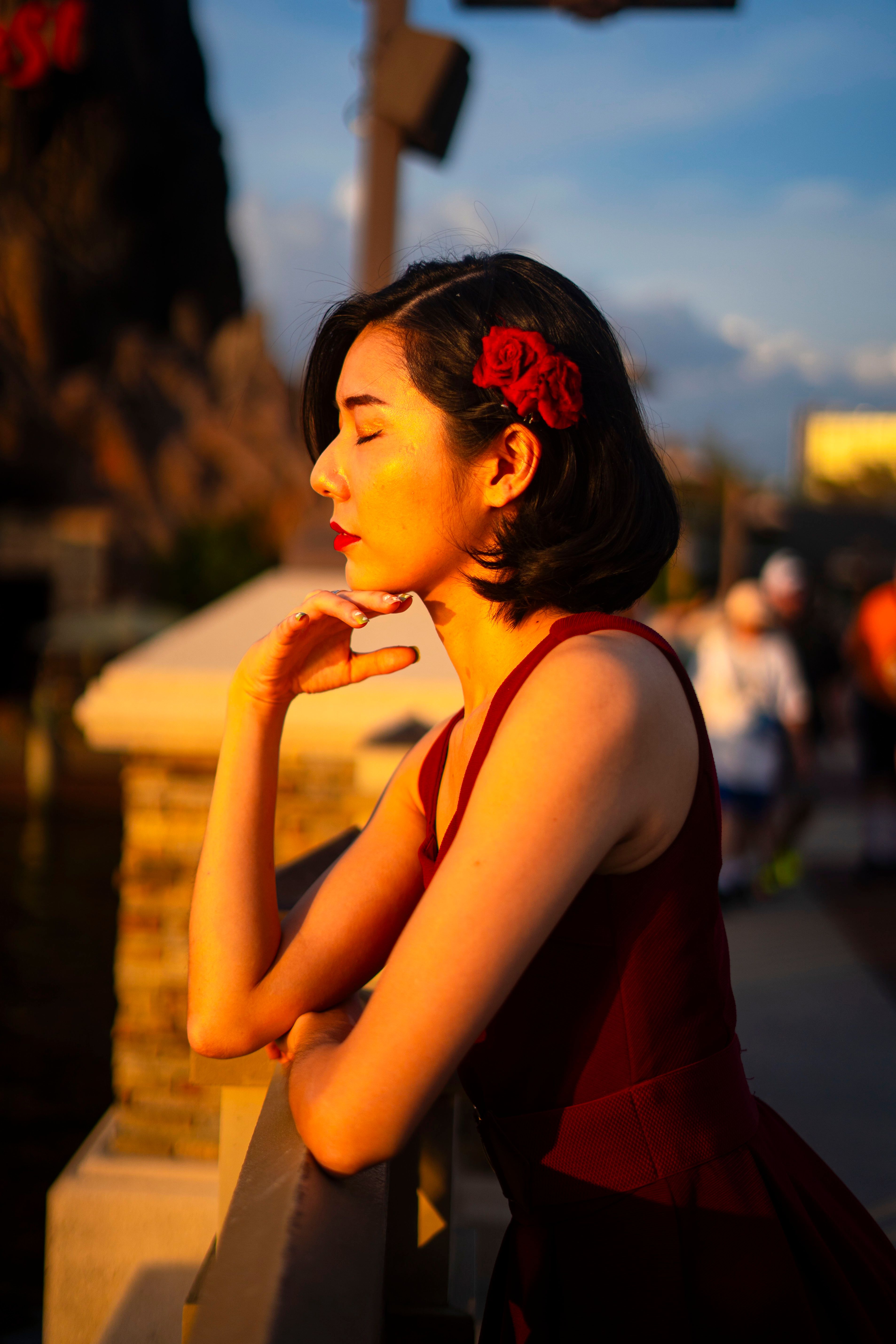 Woman in Red Dress Posing Outdoors at Sunset · Free Stock Photo
