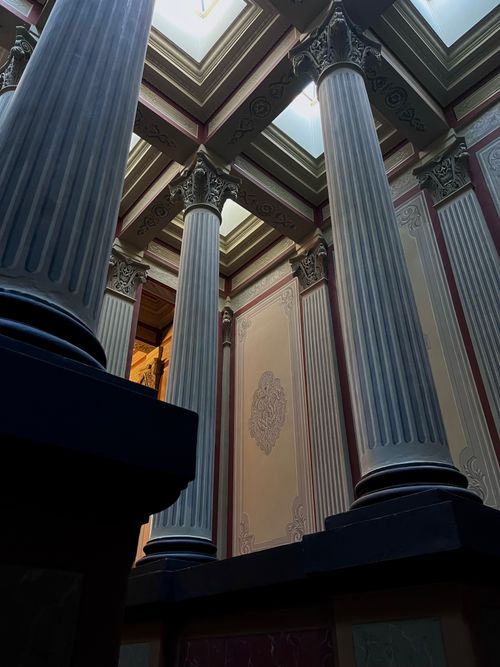 Free A striking display of neoclassical architecture showcasing towering columns in a sunlit interior. Stock Photo