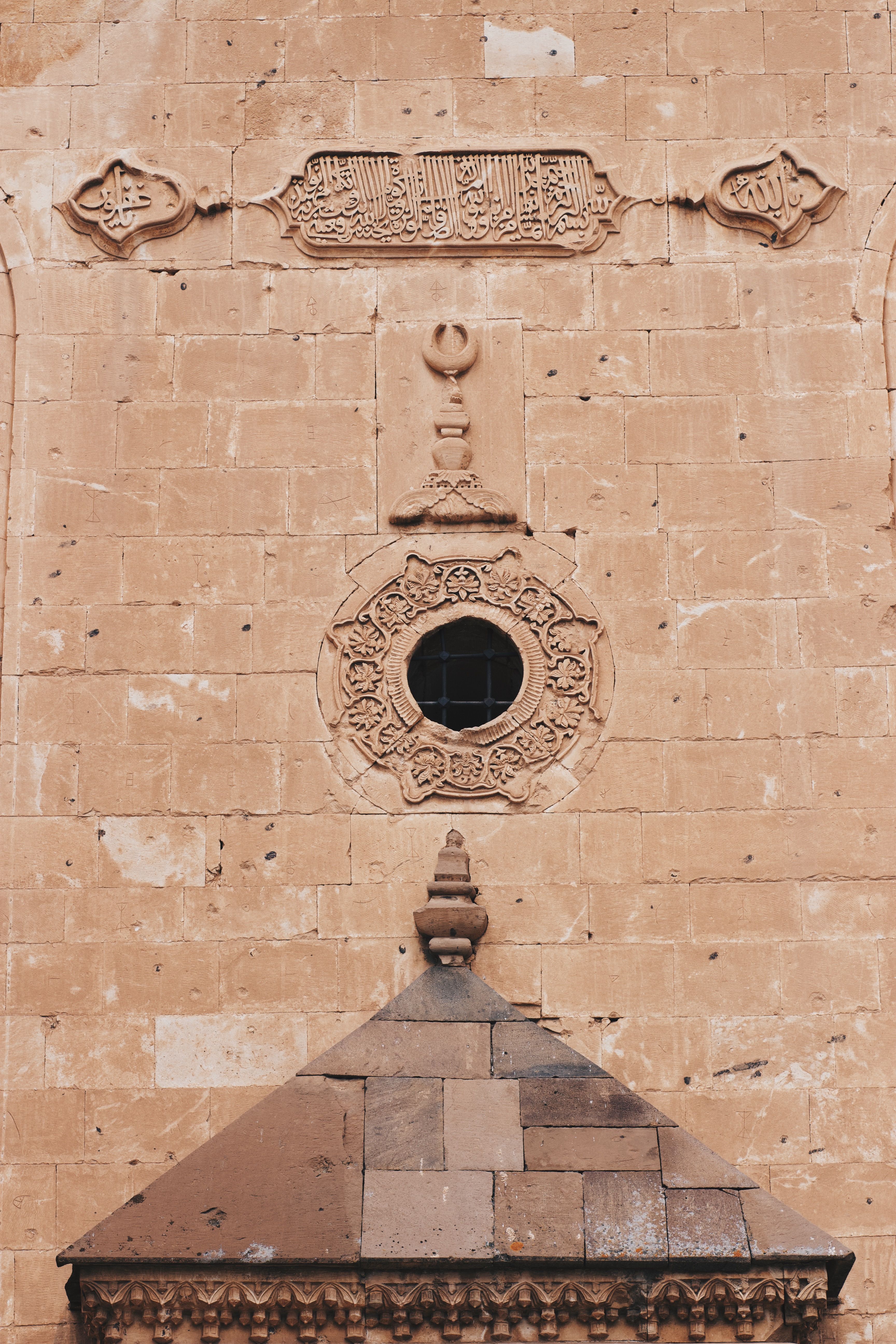 Close-up view of an ornate historic wall featuring intricate carvings and architectural details.