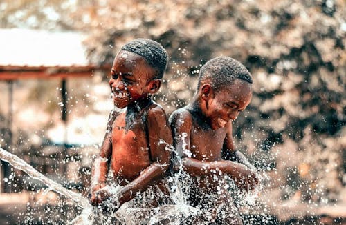 Two Boys Taking Bath Outside