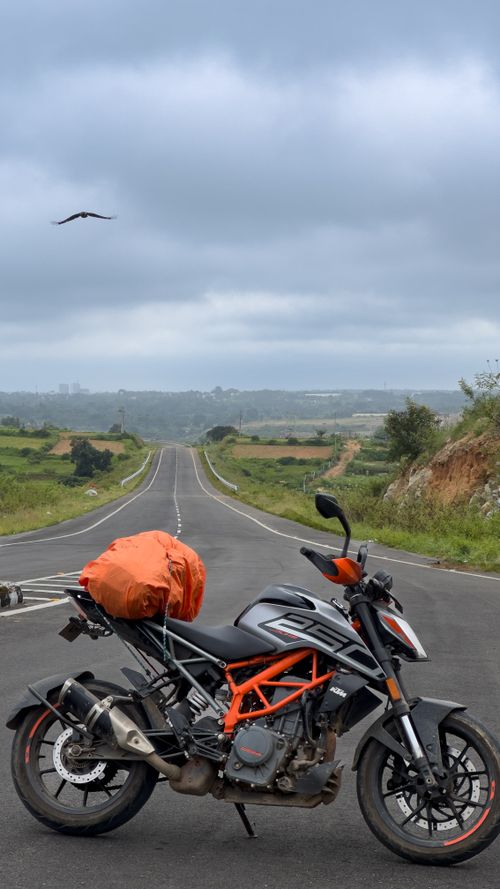 Free Explore freedom with a motorcycle journey on a scenic open road under cloudy skies. Stock Photo
