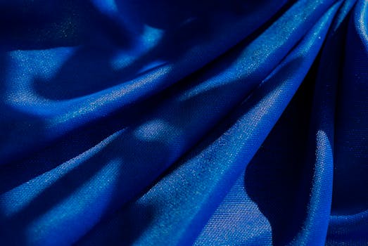 A striking image of blue fabric draped with intriguing shadows, creating a dramatic visual effect.