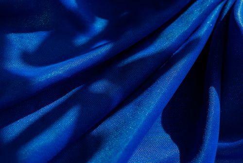 Free A striking image of blue fabric draped with intriguing shadows, creating a dramatic visual effect. Stock Photo