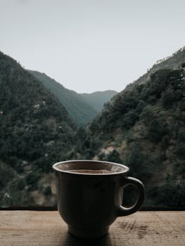 A peaceful cup of tea set against Pakistan's majestic mountains in early morning light.