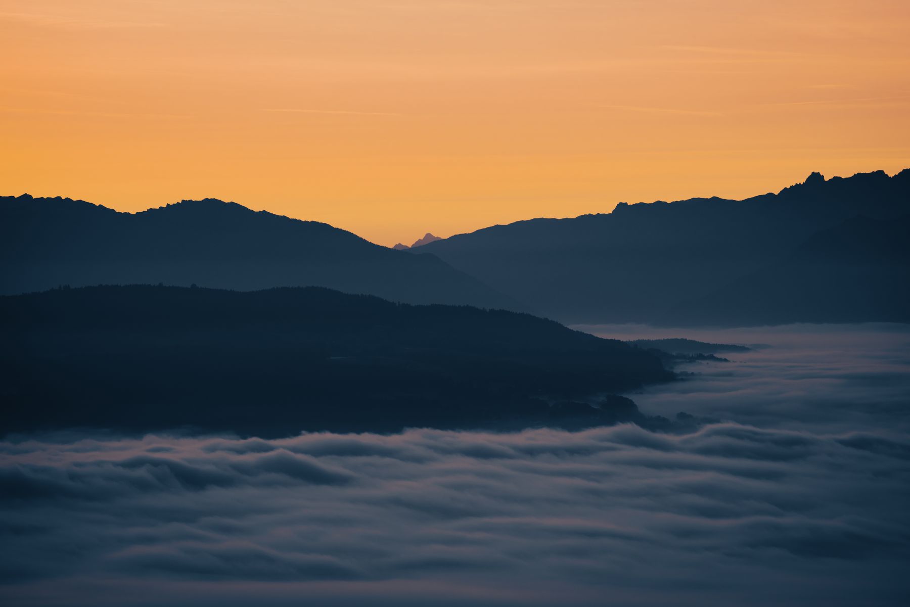 Mountain landscape at sunrise with fog
