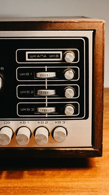 Close-up of a vintage analog radio with retro dials and wooden frame.