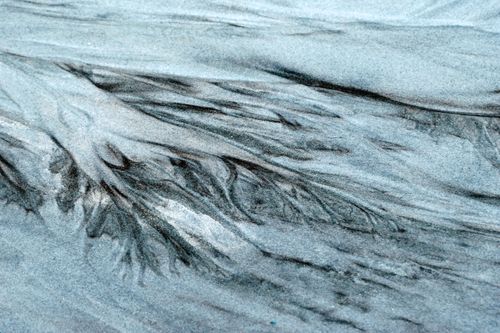 Free Abstract patterns in sand at Guaratuba Beach, Brazil create a natural artistic texture. Stock Photo