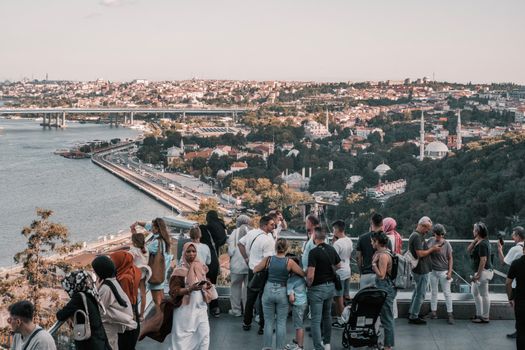 Tourists enjoying a scenic view from Pierre Loti Hill overlooking the Golden Horn in Istanbul.
