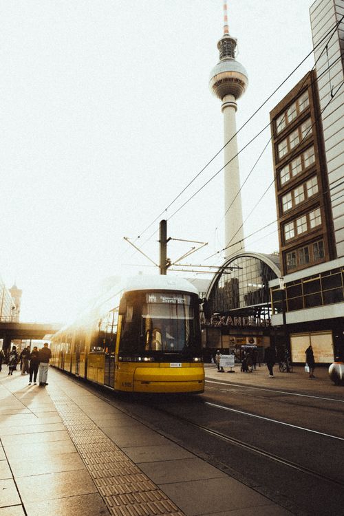 Free Capture of a Berlin tram passing Alexanderplatz during the golden hour with the iconic TV tower. Stock Photo