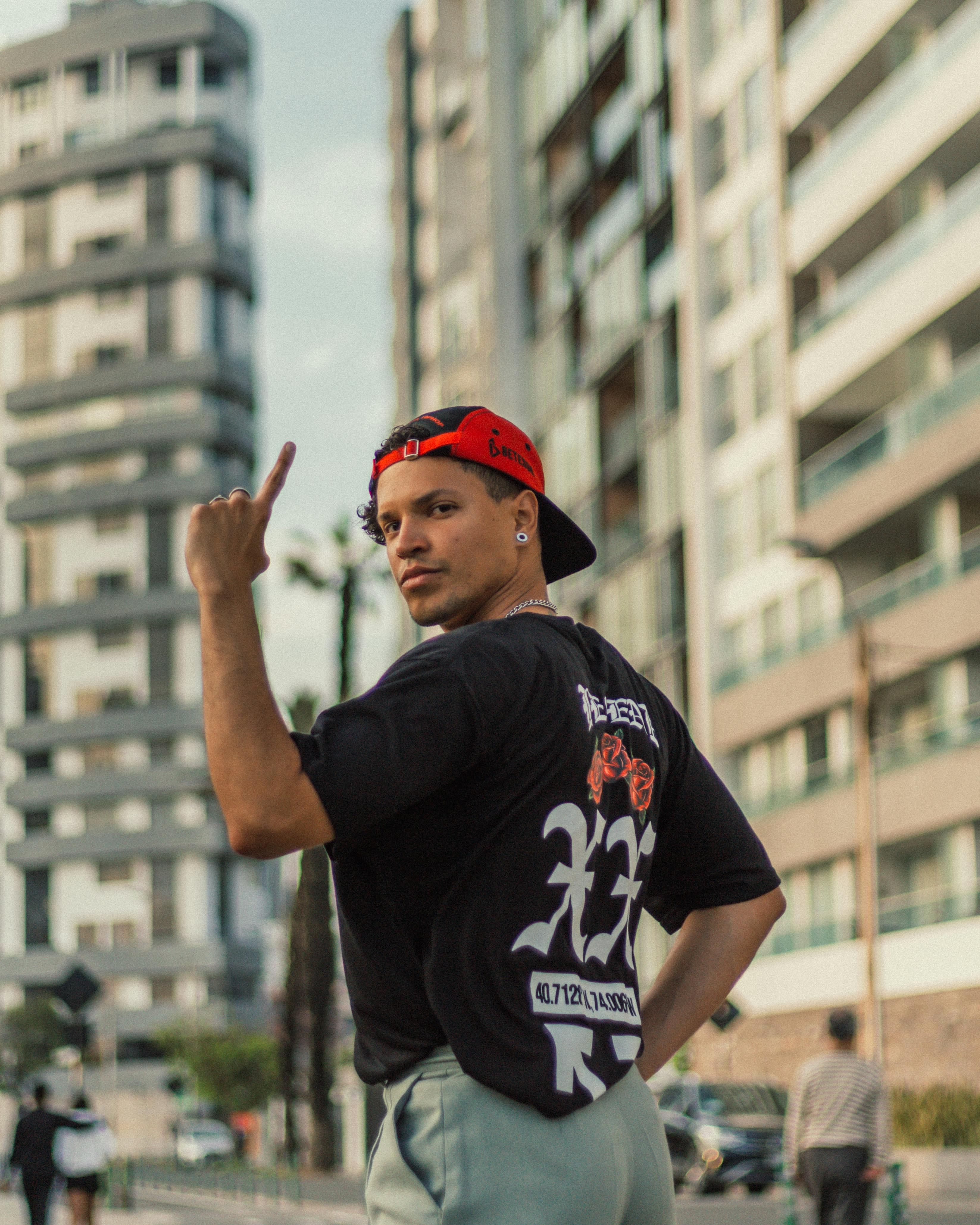 Young man expresses urban style with bold fashion in a modern cityscape.
