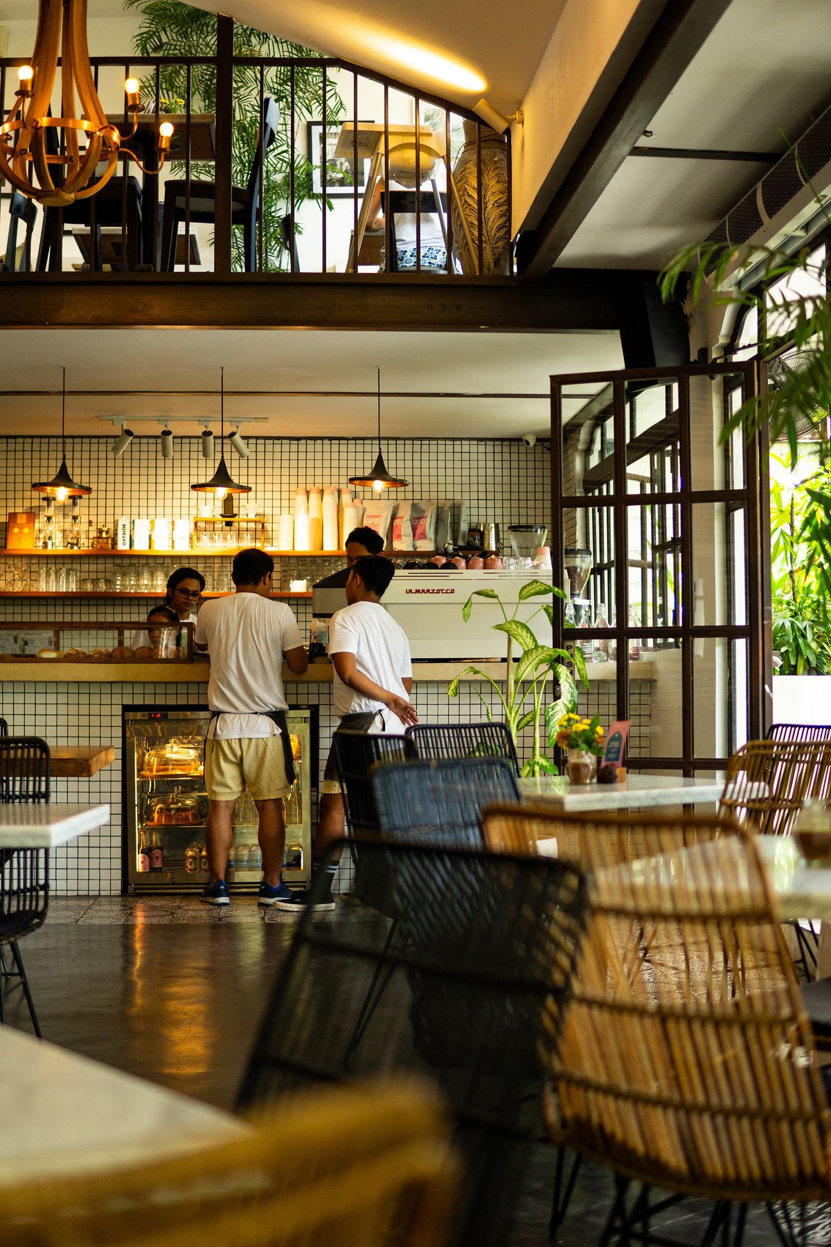 Modern independent cafe interior with customers gathered at the counter