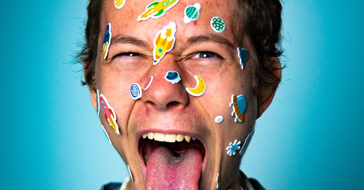 People Using Stickers Playful Young Person with Stickers on Face · Free Stock Photo