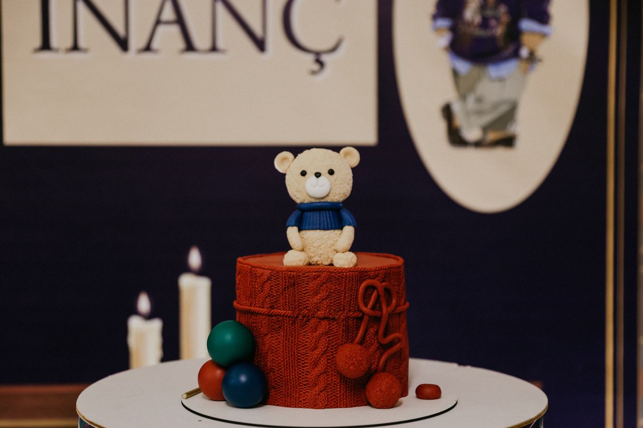 charming red cake with teddy bear topper ideal for birthday celebratio