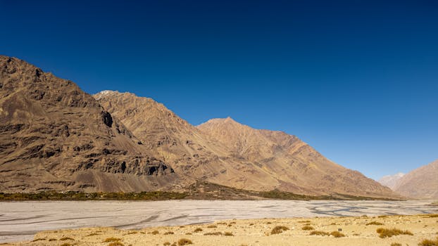Beautiful view of the rugged mountains and valleys of Ladakh under a clear blue sky.