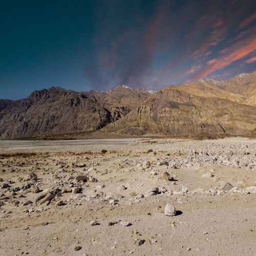 Free Breathtaking view of Nubra Valley's rugged terrain under a colorful sunset sky in Ladakh, India. Stock Photo