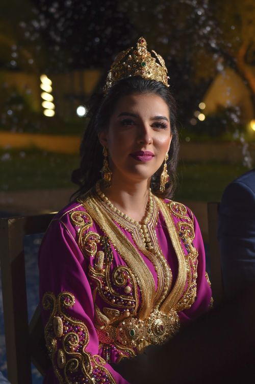 Free Beautiful woman wearing traditional Moroccan attire in Marrakesh evening. Stock Photo