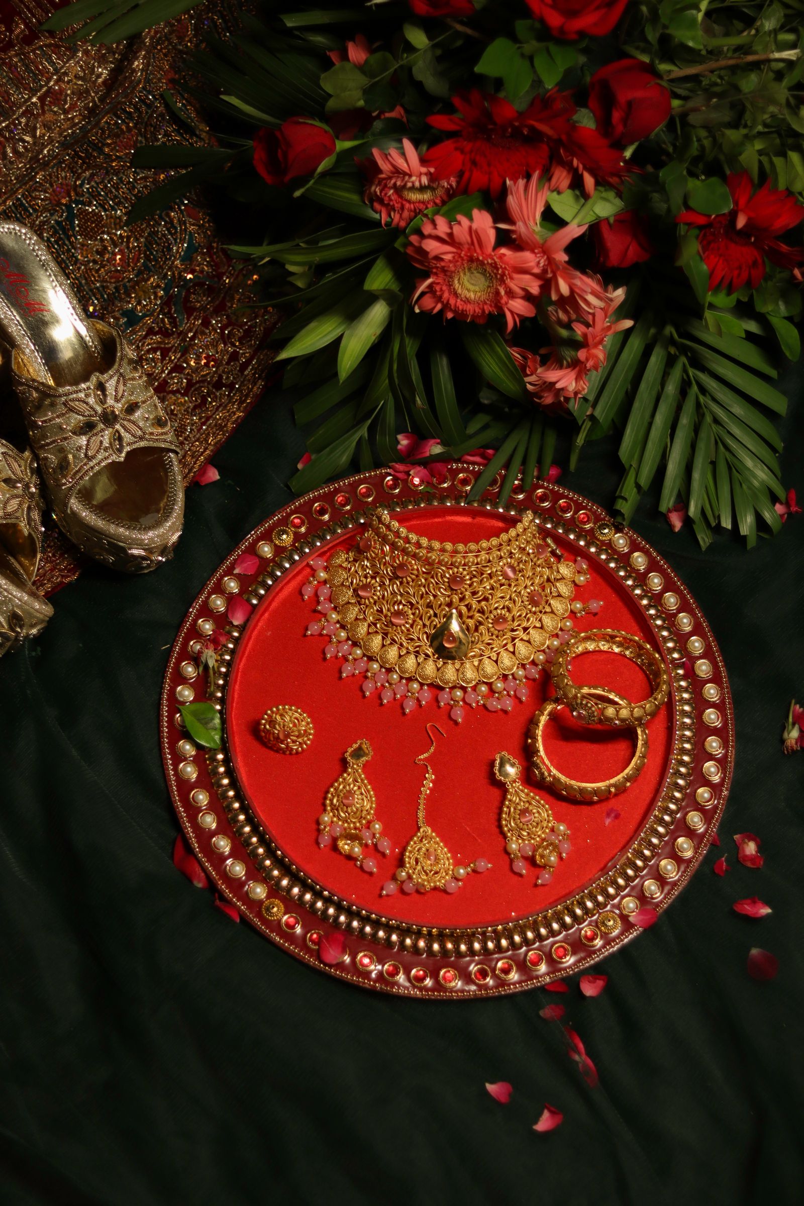 A traditional Indian bridal gold jewellery set laid out on display