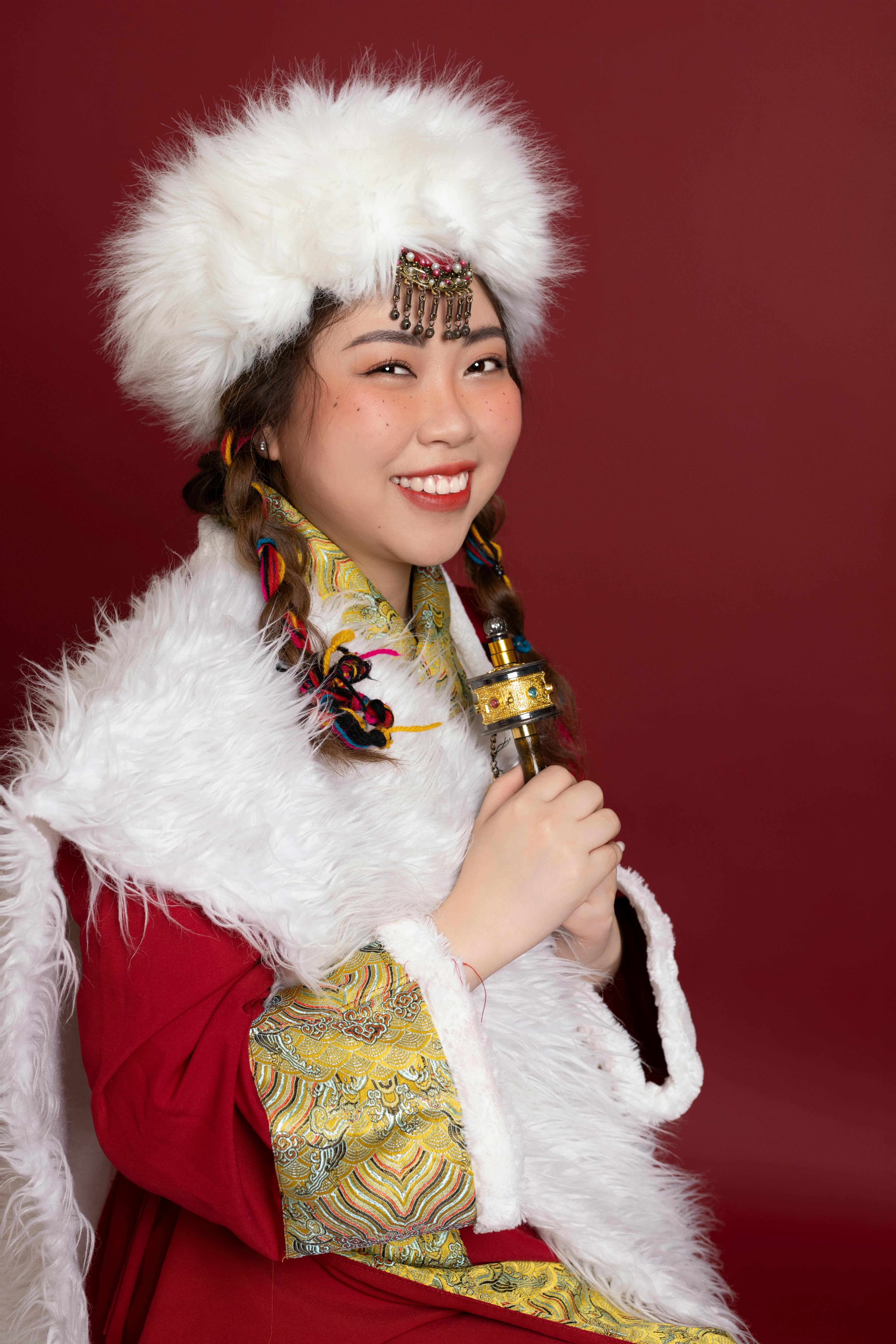 Smiling woman in traditional Vietnamese costume with intricate details and cultural significance.